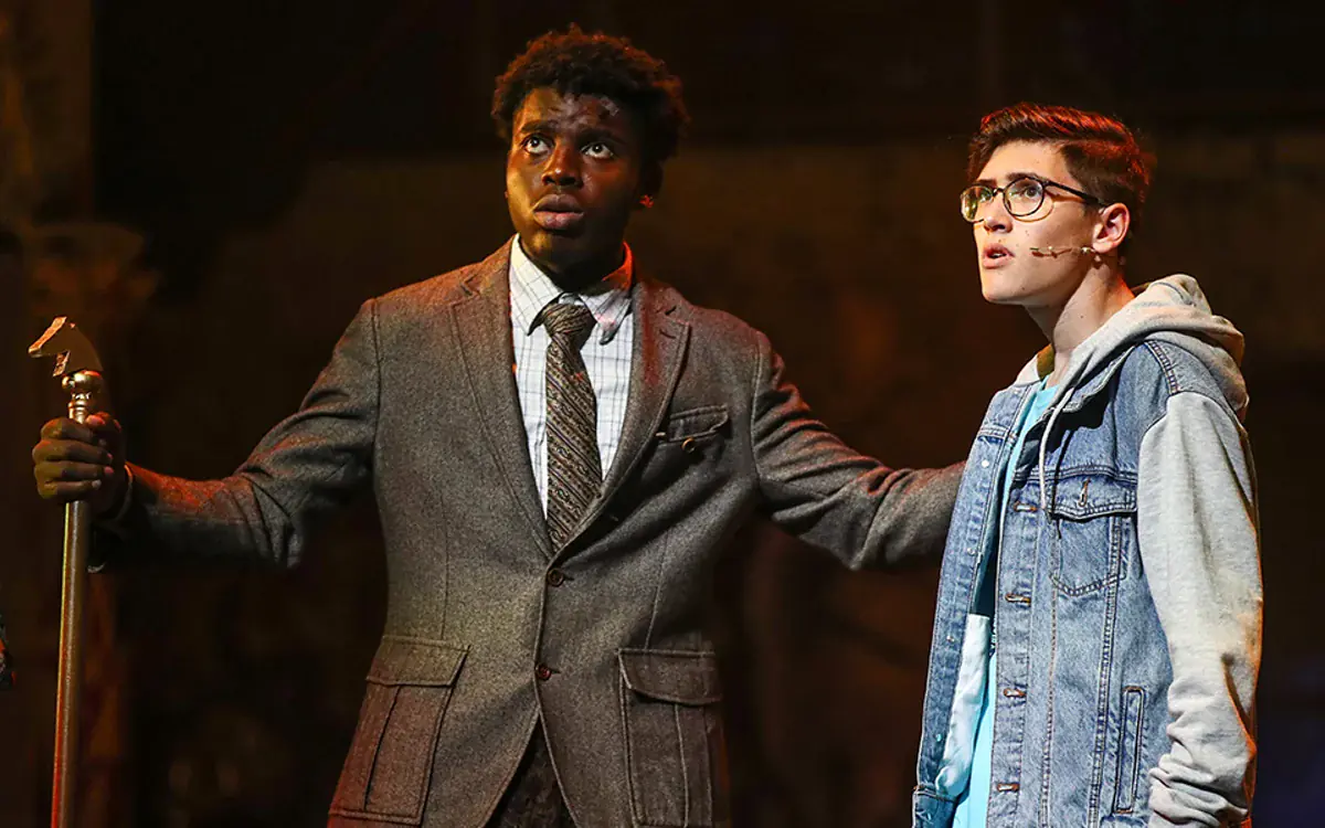 Official production photograph from The Lightning Thief musical showing Percy Jackson and Chiron on stage